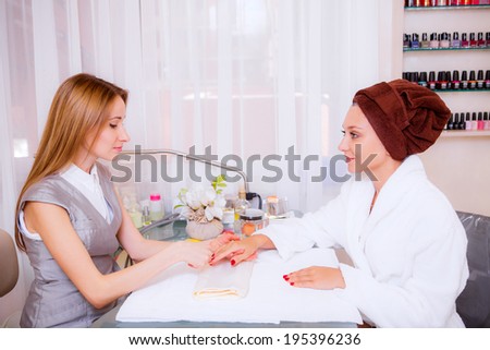 Beautiful girl in a beauty salon manicures. spa treatments.   Beauty and Health