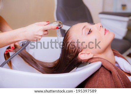 Beautiful girl in a beauty salon. wash your hair, hair care, health