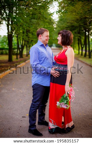 beautiful pregnant woman with her husband walks in the park. rest, relax