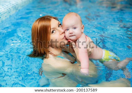happy mother and son in the pool. water treatments. prevention of diseases of the musculoskeletal system