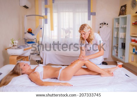 body care, body scrub for skin cream, beautiful girl on reception at the beautician