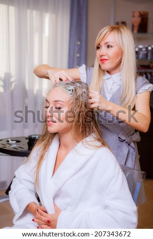Hair beauty care, moisturizer application, hairdresser, hair mask of a beautiful girl, natural, health