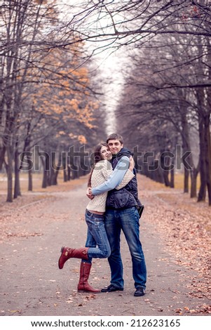young couple in autumn park. happy husband and wife for a walk. Autumn walk