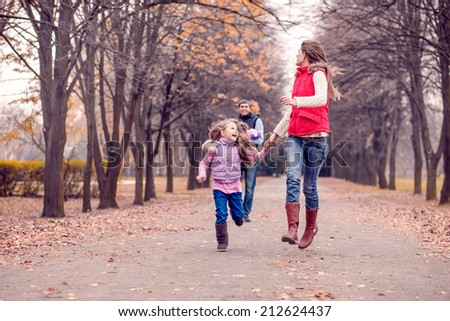 Happy family in autumn park. Autumn walk, November
