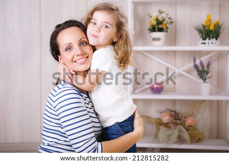 Happy mother and daughter at home. Family relationships, emotions