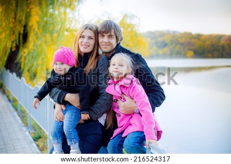 Beautiful family on walk in autumn park