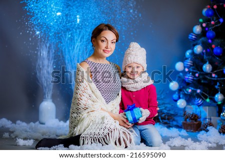 Christmas concept. happy mother and daughter in a room near the Christmas tree.gifts