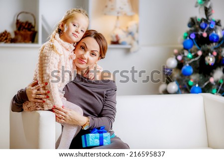 Christmas concept. happy mother and daughter in the room. give gifts