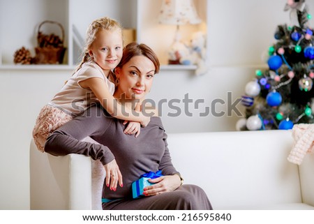 Christmas concept. happy mother and daughter in the room. give gifts