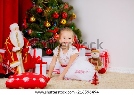 New Year\'s Concert. Adorable girl near a Christmas tree with presents. new year