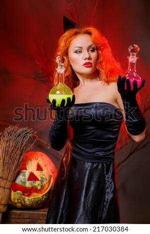 beautiful red-haired girl in a witch costume. masquerade. halloween