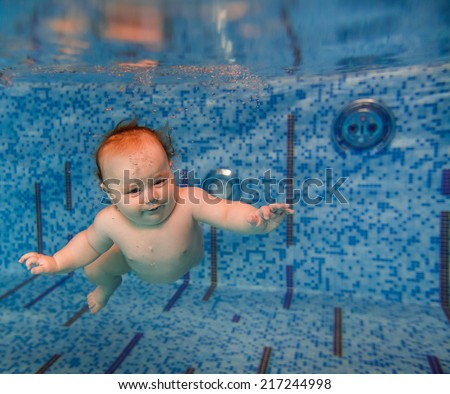 beautiful little boy swimming underwater. child development, disease prevention