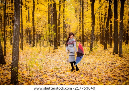 girl with umbrella rainbow colors. autumn forest. Outdoors