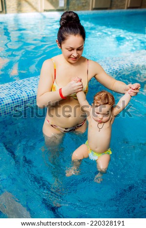 mother with a child in the pool. swimming for infants, disease prevention