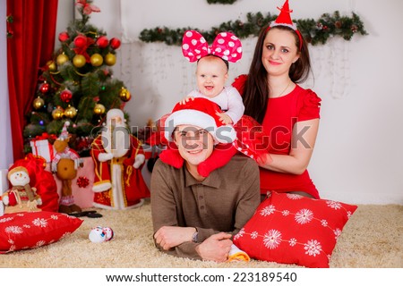 happy family near the Christmas tree. Red concept shooting, christmas