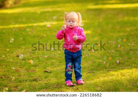 Happy girl with soap bubbles in the park. play, run, active, relaxing, fun, children\'s emotions