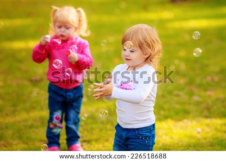 Happy kids with soap bubbles in the park. play, run, active, relaxing, fun, children\'s emotions