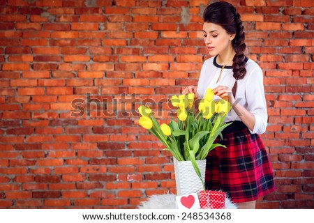 beautiful girl with a bouquet of yellow tulips. International Women\'s Day. On March 8, Mother\'s Day