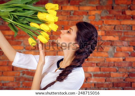 beautiful girl sniffing tulips. International Women\'s Day. On March 8, Mother\'s Day, Valentine\'s Day