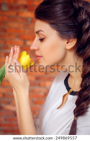 beautiful girl with yellow tulip. close-up, International Women\'s Day, Valentine\'s Day, March 8, Mother\'s Day