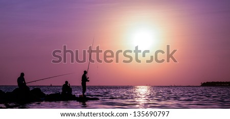 Fishermen fishing in jeddah red sea at sunset