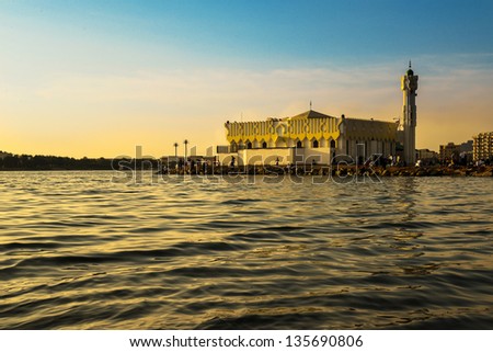 Mosque in jeddah beach at sunset & people around it Mosque in jeddah beach at sunset & people around it