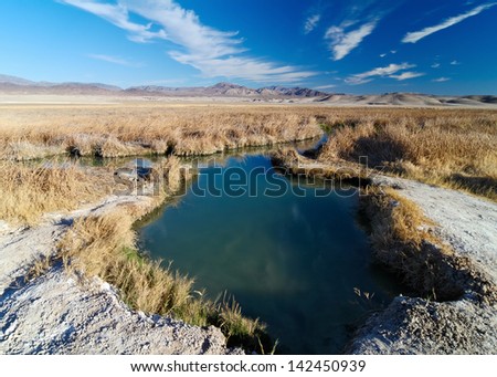 Tecopa Hot Pond. A collection of hot springs feed a pond in the open desert adjacent to the small town of Tecopa. The pond is used for mud bathing. Tecopa, Inyo County, California, USA.
