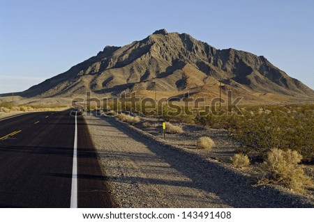 Desert road. Shows Eagle Mountain in the background  and Highway 127, California, USA. On Hwy 127, south of Death Valley Junction.
