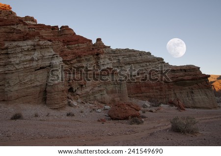 'Red Cliffs' at Red Rock Canyon State Park in Kern County, California, USA. Composite of two images, one for the moon and one for the cliffs. Only the rising moon phase is accurate on January 3, 2015.