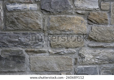 Rock and cement wall texture. Each rock is different and bits of minerals are exposed.