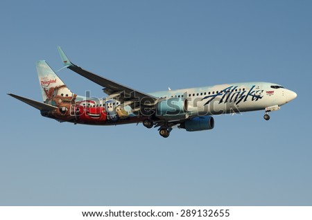 LOS ANGELES, CA/USA - JUNE 20 2015: Alaska Airlines Boeing 737-800 (reg N570AS) shown approaching LAX (Los Angeles World Airport). This Disney-themed plane is named  Adventure of Disneyland Resorts.