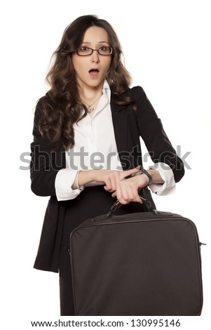 young business woman pointing a finger at the clock it was time to go