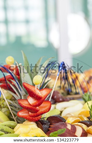 Catering arrangements with fruit and strawberries with a focus on the foreground