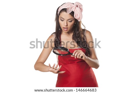 Shocked housewife watching her nails through magnifying glass