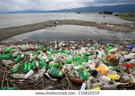 A Pile Of Garbage And Plastic Bottles On The Lake Shore