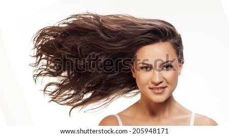 Pretty girl with long blowing wavy hair