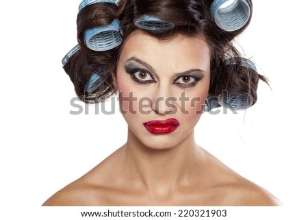 Funny woman with curlers and bad makeup with questionable gesture