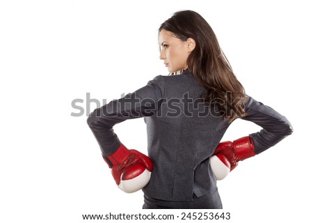 Back view of business woman with boxing gloves on a white background