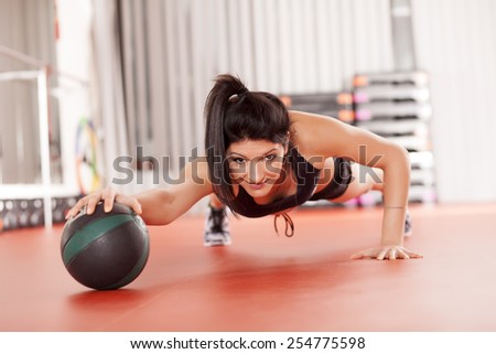 pretty young woman doing exercises with a medicine ball