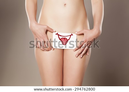 Happy gesture drawn on paper in front of her vagina