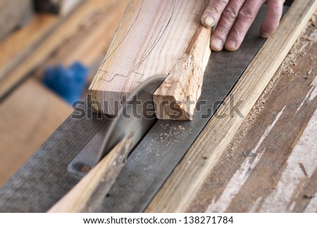 Man with a machine for cutting wood