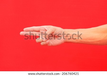 Hand show two finger on isolated red background for graphic designer