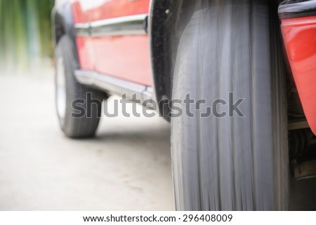 Car tire on the road ready to go with motion blur
