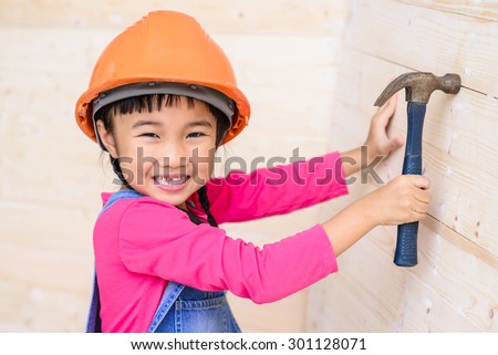Kid engineer with carpenter work funny on job