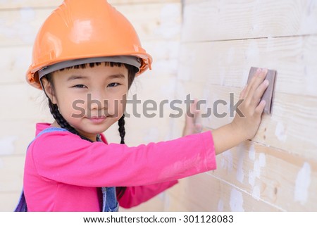 Kid with carpenter work portrait sanding on wood