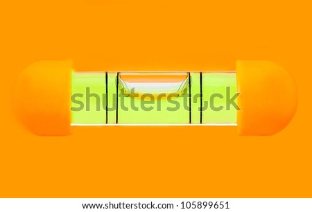 Green bubble level in orange background