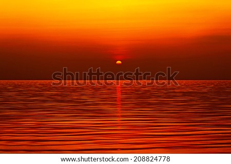 gold sun setting over the sea