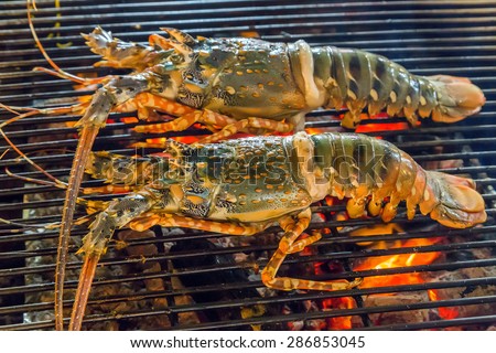 lobster dinner at the restaurant seafood by fire and BBQ Flames. Restaurant Barbecue at the night market