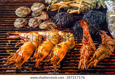 Flame Grilled Shrimp seafood by fire and BBQ Flames. Restaurant Barbecue at the night market