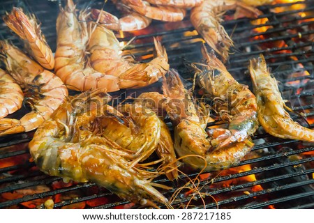 delicious prawn seafood by fire and BBQ Flames. Restaurant Barbecue at the night market